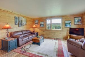 a living room with leather furniture and a flat screen tv at Red Lodge Vacation Rental with Mountain Views! in Red Lodge