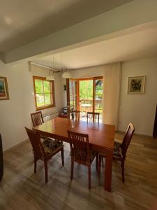 a dining room with a wooden table and chairs at VILA VALANGA in Bovec