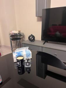 a room with a table with a tv and a chair at Luxury hotel apartment in Istanbul