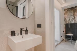 a bathroom with a white sink and a mirror at VillaLume in Marina di Castagneto Carducci +71 photos