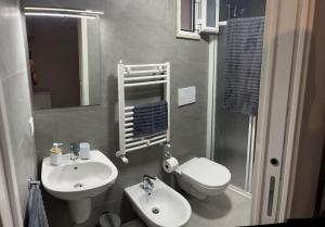 a bathroom with a sink and a toilet and a shower at Le Mura di Gabry in Bari
