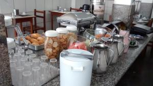 a kitchen counter filled with lots of food at Hotel Alvorada in Goiânia