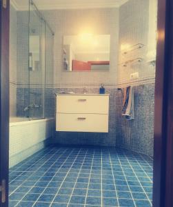 a bathroom with a sink and a shower at Atico Rias Baixas in Vilagarcia de Arousa