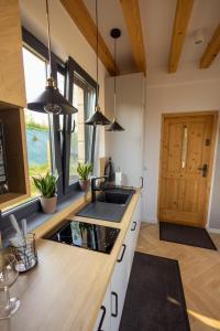 a kitchen with a sink and a counter top at RUBIESZCZA domek z widokiem na jezioro in Wołkowyja