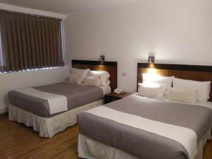 Postel nebo postele na pokoji v ubytování Global Hotel