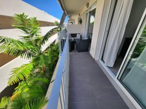 a balcony of a house with palm trees and plants at Chill Out Tesoro in Adeje