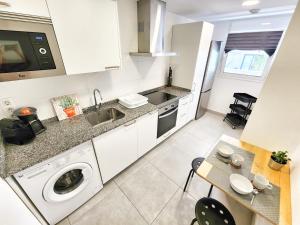 a kitchen with a sink and a washing machine at Chill Out Tesoro in Adeje