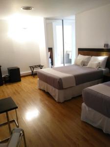Postel nebo postele na pokoji v ubytování Global Hotel