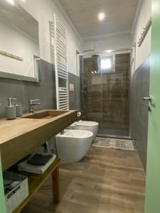 a bathroom with a toilet and a sink and a shower at Casa Paolina in Uggiano la Chiesa