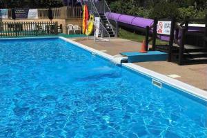 - une piscine vide avec un toboggan pourpre dans l'établissement The Cosy Cabin - Bideford Bay Holiday Park, à Bucks Mills