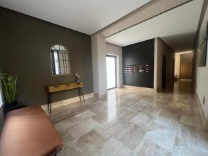 an empty room with a table and a hallway at Apartamentos Aurea in Benidorm