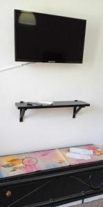 a flat screen tv hanging on a wall at Andros Lighthouse Apartments in Mesariá