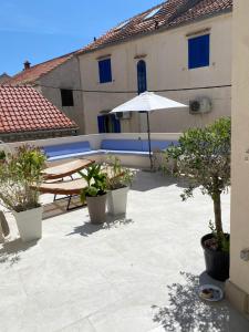 a patio with a table and an umbrella at Apartment 7 in Bol