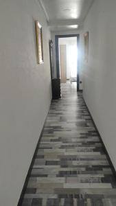 a hallway with white walls and a tile floor at Precioso piso en Ourense centro in Ourense
