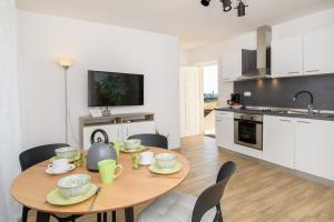 a kitchen and dining room with a table and chairs at Apartments & Rooms Darrer in Poreč