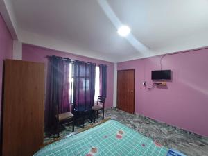 Habitación con piscina en una habitación con paredes púrpuras. en Odyssey Stays Nongrim, Cherrapunji, en Cherrapunji