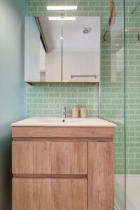 a bathroom with a sink and a glass shower at Comfortable Town House in Quiet Area by LovelyStay in Lisbon