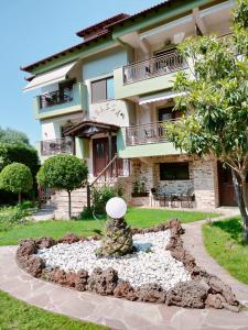 a building with a statue in front of a building at Anassa Deluxe Apartments & Studios in Skala Potamias