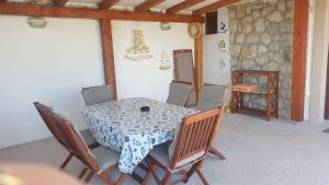 einen Tisch und Stühle in einem Zimmer mit einem Tisch, einem Tisch und einem Tisch in der Unterkunft TAKOMA in Čunski