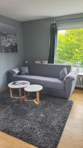 a living room with a couch and a table at Meerblick in Glücksburg