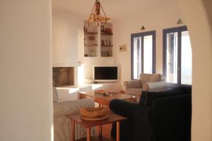 a living room with a couch and a table at Alia's sea view villa & studios in Apróvaton