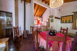 a dining room with a table with a tea kettle on it at Cabaña en Alta Montaña - Complejo Cabañas del Pastizal - USPALLATA, MENDOZA in Uspallata