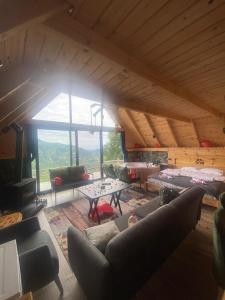a large living room with a couch and a table at ONASUITBUNGALOW in Rize
