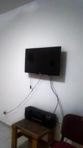 a flat screen tv hanging on a wall next to a table at Rania Chalet -Stella Di Mare Sea view- Families in Ain Sokhna