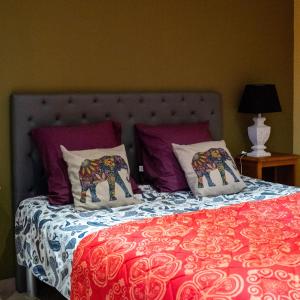 uma cama com duas almofadas de elefante em Appartement d'une chambre avec jardin clos et wifi a Fauverney em Fauverney