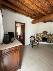 a living room with a couch and a fireplace at Aloni Farmhouse in Karistos