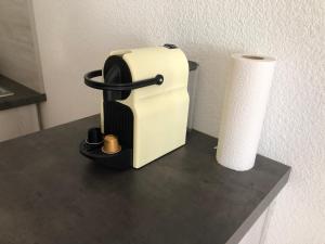 a toaster and a roll of toilet paper on a counter at Studio au pied des sentiers in Villard-de-Lans