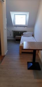 a room with two beds and a window at Ferienwohnung Scholl in Pforzheim