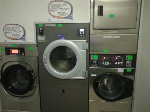 a washing machine and a washer and dryer at Hotel Regina del Bosco in Ronzone