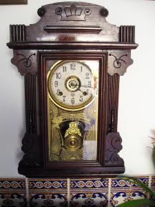 a grandfather clock is hanging on a wall at Solar de Mos in Lagos