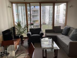 a living room with a couch and a table at Luxury Apartment close to Convention Centre in Dublin