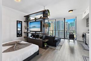 a bedroom with a large bed and a living room at Corner condo w/ Unrivaled views in Miami