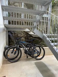 a bike is parked under a staircase at Amazigh Hostel & Suites in Aljezur