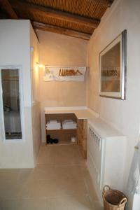 a bathroom with a sink and a washing machine at B&B Pulia Dimore Salentine Leuca in Alessano