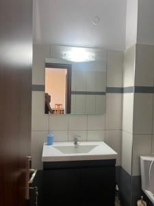 a bathroom with a sink and a mirror at Sunset Apartment in Vonitsa