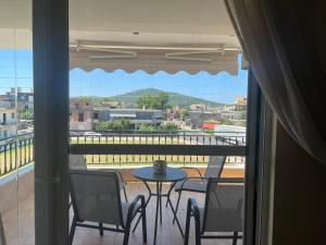 a view of a balcony with a table and chairs at Sunset Apartment in Vonitsa