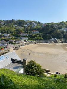 a view of a beach with people on the sand at 2 bed apartment overlooking North Sands beach in Salcombe