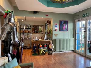 a living room with two people standing in a room at Knights Court Hotel in Great Yarmouth
