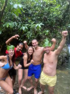 a group of people standing in the water at Sumatra Jungle Trek In & Orangutan Trips in Bukit Lawang
