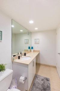 a bathroom with a sink and a mirror and a toilet at Amazing apartment on the beach in Hollywood