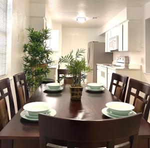 a dining room table with chairs and a kitchen at Downtown in Plano in Plano
