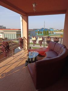 a living room with a couch and a table on a balcony at ROYAL Apartmani in Bosanski Šamac