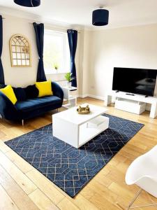 a living room with a couch and a tv at JB Stays Croydon Townhouse in South Norwood