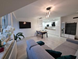 a living room with a couch and a table at Apartament C22 in Darłowo