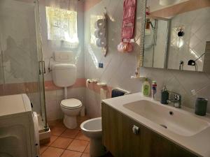 a bathroom with a sink and a toilet and a mirror at Enea residence in Pozzuoli +29 photos