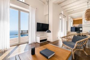 a living room with a view of the ocean at Villa Olivia Mykonos in Agios Stefanos